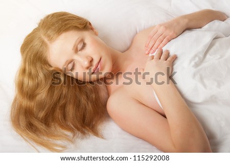 young beautiful woman sleeping in white bed net