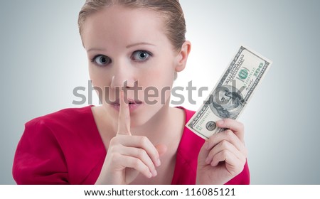 woman with money, dollars  raised her finger to her mouth and says 