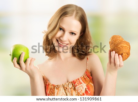 woman with a bun and apple choose between healthy and unhealthy food