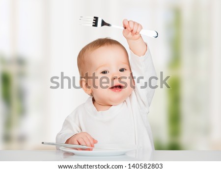 Funny Happy Baby With A Knife And Fork Eating Food
