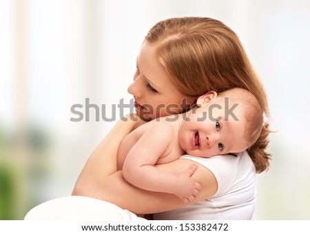 happy family mother and baby little girl hugging happy family mother and baby little girl hugging