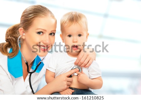 baby at the doctor pediatrician. doctor listens to the heart with a stethoscope