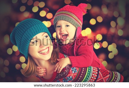 happy family mother and baby little daughter playing in the winter for the Christmas holidays
