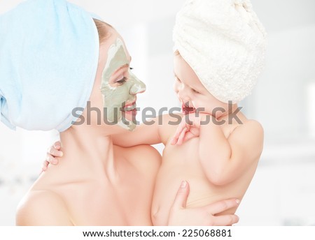 family beauty treatment in the bathroom. mother and daughter baby girl make a mask for a face skin