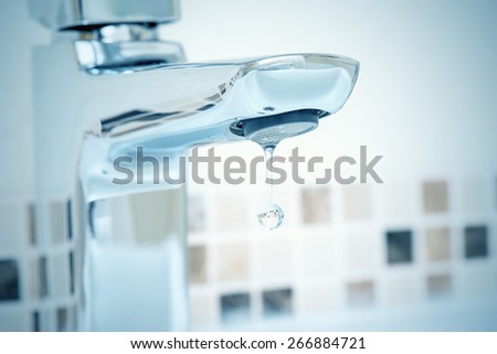 water tap and water dripping from it