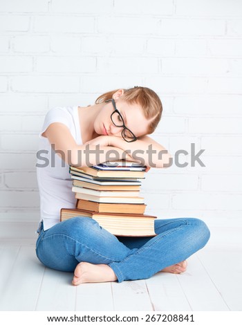 tired student girl in glasses asleep hugging books