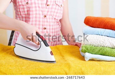 housewife happy woman with iron engaged in domestic work