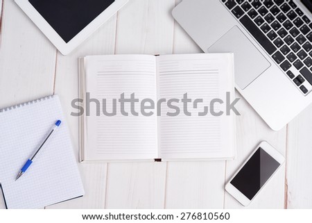 Workplace business still life. blank empty notebook, laptop, tablet pc, mobile phone, pen