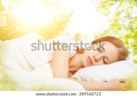 the concept of rest and relaxation. woman sleeping in bed on the background of nature