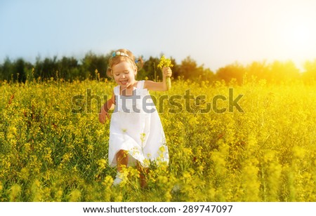 happy little child girl in a white dress running on field with a bouquet of yellow flowers, wildflowers