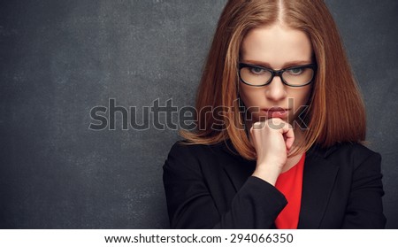 serious stern woman teacher at the blackboard