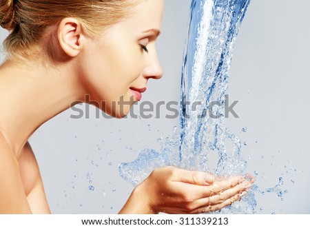 Beauty woman skin care, washing with splashes and drops of water