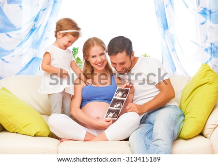 Happy family waiting for baby looking ultrasound pregnant mom, dad, child daughter