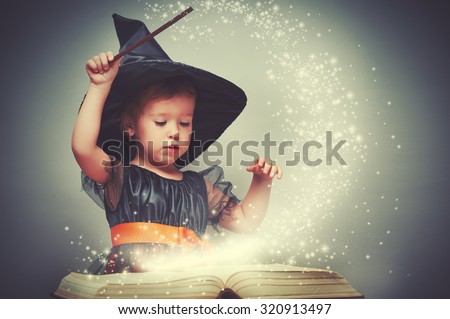 Halloween. cheerful little witch with a magic wand and glowing book conjure and laughs.