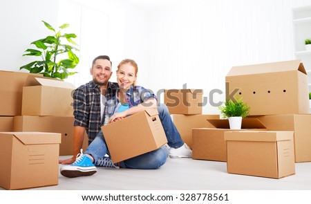 moving to a new apartment. Happy family couple and a lot of cardboard boxes.