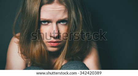 sad woman in depression and despair  on black dark background