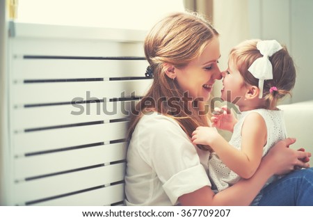 Happy loving family. mother and child girl playing, kissing and hugging