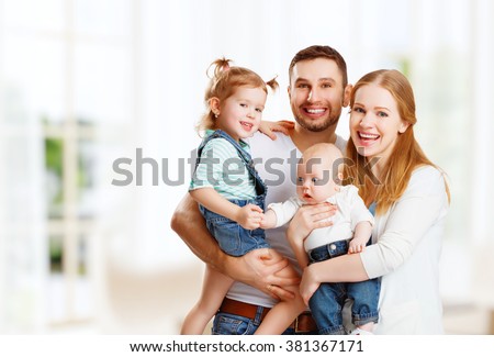 happy family mother, father and two children at home
