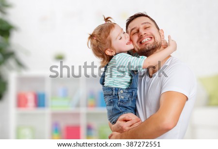 happy family and father\'s day. child daughter kissing and hugging dad