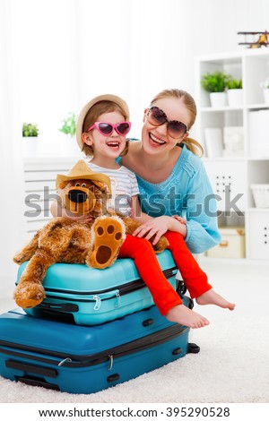 happy family tourist mother and child daughter suitcases packed for vacation