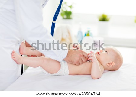 the Doctor pediatrician stethoscope listening to baby