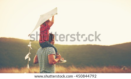 happy family father and child on meadow with a kite in the summer on the nature