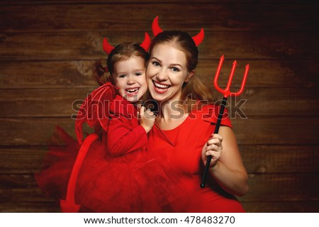 Family fun mother and child daughter having fun and celebrate Halloween in devil costume