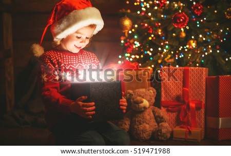 happy child girl with a magic Christmas gift