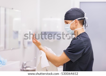 Doctor surgeon preparing for surgery and washes his hands
