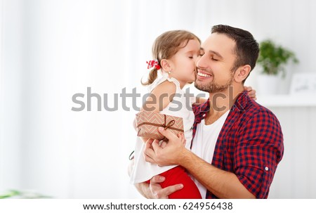 Father\'s day. Happy family daughter hugging dad and laughs on holiday