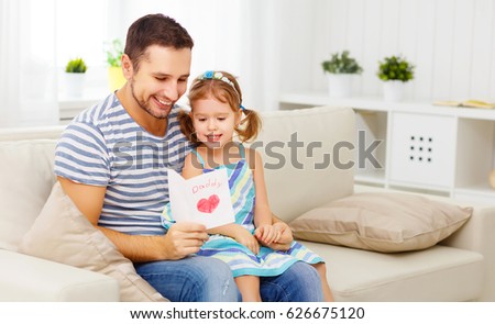 Father\'s day. Happy family daughter giving dad a greeting card on holiday