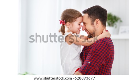 Father\'s day. Happy family daughter hugging dad and laughs on holiday