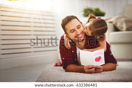 Father\'s day. Happy family daughter kiss dad and giving greeting card  on holiday