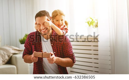 Father\'s day. Happy family daughter hugging dad and laughs on holiday