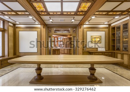 Entrance into the living room made of wood in a large ecological house. In room stands large long table on the marble floor. Design modern and eco style. New repair.