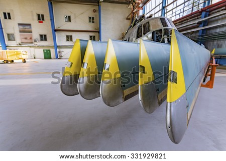 Helicopter rotor blades in aviation hangar for painting. Repair and modernisation work the passenger aircraft.