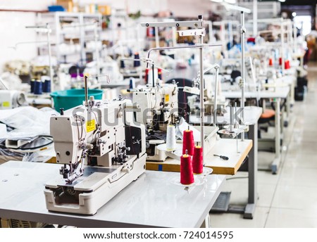 Interior of garment factory shop. Closes making atelier with several sewing machines. Tailoring industry, fashion designer workshop, industry concept