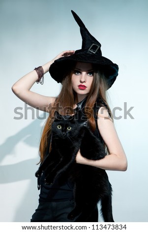 Beautiful witch with black cat. Halloween.