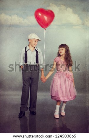 Cute children walk with a red balloon. Photo in retro style with old textured paper.