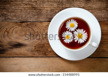 herbal tea with chamomile on old wooden table. Top view. With place for text.