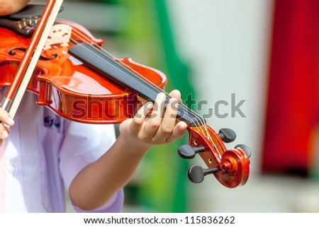 Students learn to play the violin.
