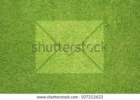 Email icon on green grass texture and  background