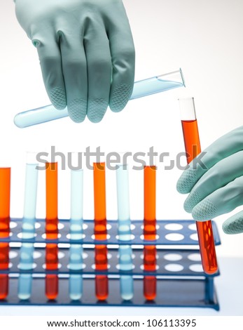 Scientist working in a laboratory , glass containing liquid color