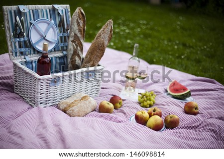 Wine and picnic basket on the grass