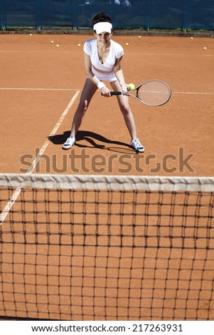 Young woman tennis player on the court