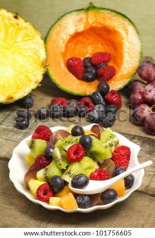 greedy fruit salad with red fruits and  fruits background