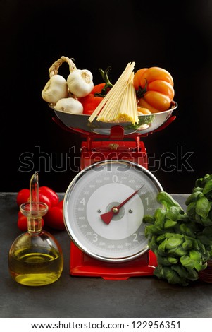 mediterranean diet food over kitchen scales