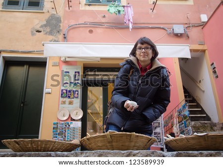 female tourist visiting ceramic shop in vernazza, italy