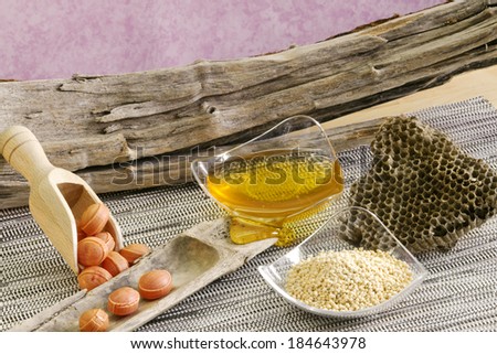 honey,pollen, beehive and honey bonbons on wooden background