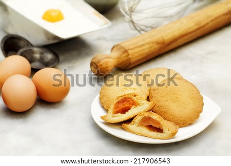 short pastry cookies with ingredients and kitchen utensils